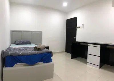 a bedroom with a bed and a flat screen tv at 4 Bedrooms Semi D Homestay by Mr Homestay in Kulim