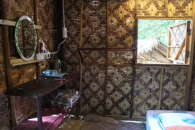 a bathroom with a sink and a mirror and a window at Rain Forest Inn in Ringlet