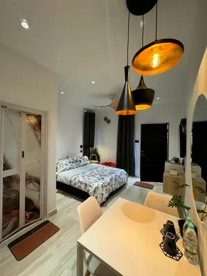 a living room with a bed and a table at Cozy Scandinavi Guest room - Queen Bed, Free Netflix, Prime & Wi-Fi Near Bukit Mertajam in Kubang Semang