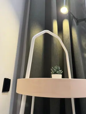 a wooden bench with a potted plant on it at Cozy Scandinavi Guest room - Queen Bed, Free Netflix, Prime & Wi-Fi Near Bukit Mertajam in Kubang Semang