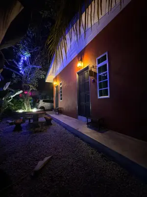 a night view of a building with a table outside at Cozy Scandinavi Guest room - Queen Bed, Free Netflix, Prime & Wi-Fi Near Bukit Mertajam in Kubang Semang