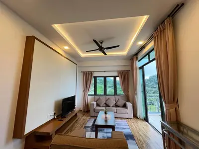 a living room with a couch and a ceiling fan at Delisha 2 Homestay 3R2B The Retreat Nova Kae Farm in Brinchang
