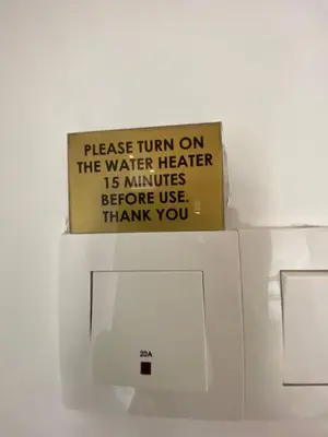 a sign is on top of a microwave at Delisha 2 Homestay 3R2B The Retreat Nova Kae Farm in Brinchang