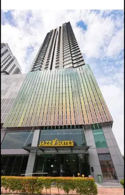 a tall building with a katz suites sign on it at jazz suite 2 bedroom sea view apartment in Tanjung Bungah