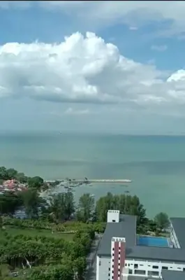 a view of a city with a building and a body of water at jazz suite 2 bedroom sea view apartment in Tanjung Bungah