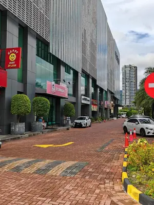 a city street with cars parked in front of a building at jazz suite 2 bedroom sea view apartment in Tanjung Bungah