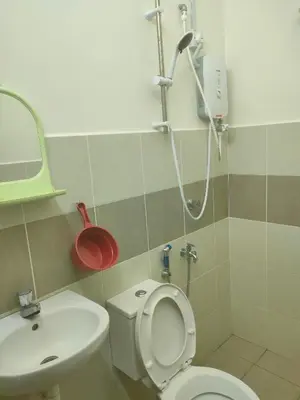 a bathroom with a shower and a toilet and a sink at Homestay Fayyadh Teluk Intan 3Room2Bath in Teluk Intan