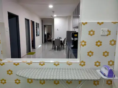 a room with a kitchen and a dining room at Homestay Fayyadh Teluk Intan 3Room2Bath in Teluk Intan