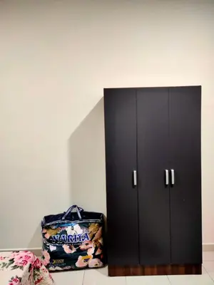 a black cabinet with a bag next to it at Homestay Fayyadh Teluk Intan 3Room2Bath in Teluk Intan