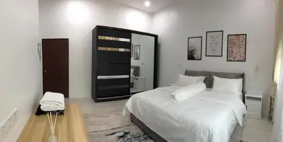 a bedroom with a white bed and a mirror at Homestay Muslim Gunung Rapat Ipoh in Ipoh