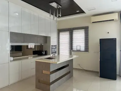 a kitchen with white cabinets and a blue refrigerator at Bichrome Marina Island Private Villa Pangkor Lumut in Lumut