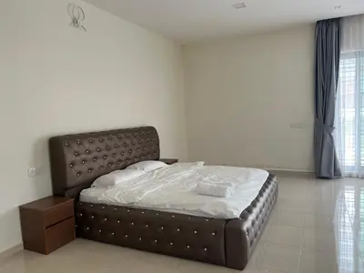 a bedroom with a large bed with white sheets at Bichrome Marina Island Private Villa Pangkor Lumut in Lumut