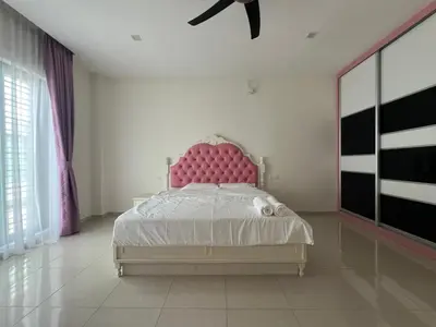 a bedroom with a pink bed with a pink headboard at Bichrome Marina Island Private Villa Pangkor Lumut in Lumut