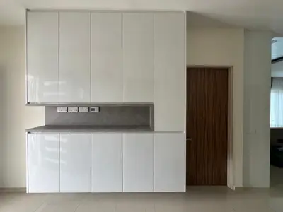 a white kitchen with white cabinets and a door at Bichrome Marina Island Private Villa Pangkor Lumut in Lumut