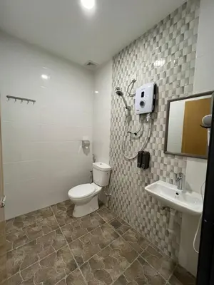 a bathroom with a toilet and a sink at KIWI INN in Taiping