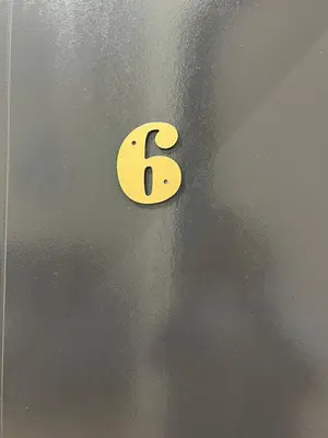 a yellow letter b on a metal wall at KIWI INN in Taiping