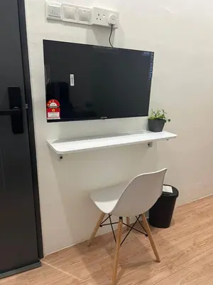 a white chair sitting in front of a desk at KIWI INN in Taiping