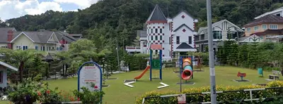 a playground in front of a large building at CH Homestay Tanah Rata, Cameron Highlands, Keyless Entry in Tanah Rata