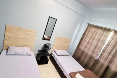 a bedroom with two beds and a mirror and a window at CH Homestay Tanah Rata, Cameron Highlands, Keyless Entry in Tanah Rata