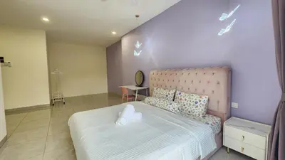 a bedroom with a large bed with a pink wall at La Belle Maison 12 @ Gurney Kelawai/Pulau Tikus/Georgetown in George Town