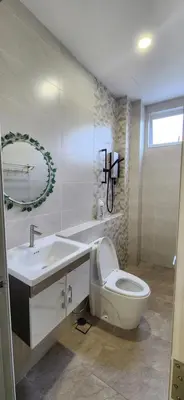 a white bathroom with a toilet and a sink at La Belle Maison 12 @ Gurney Kelawai/Pulau Tikus/Georgetown in George Town