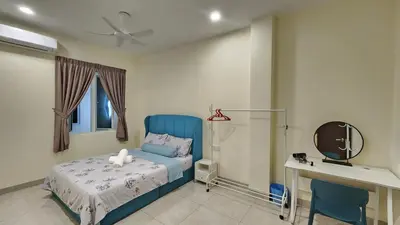 a bedroom with a blue bed and a desk at La Belle Maison 12 @ Gurney Kelawai/Pulau Tikus/Georgetown in George Town