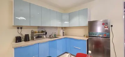 a kitchen with blue cabinets and a stainless steel refrigerator at La Belle Maison 12 @ Gurney Kelawai/Pulau Tikus/Georgetown in George Town