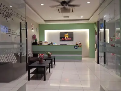 a lobby of a store with benches and a counter at Star Bay Hotel in Lumut