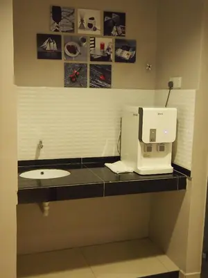 a kitchen counter with a sink and a coffee maker at Star Bay Hotel in Lumut