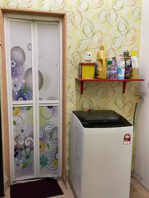a small refrigerator in a room with a wall at Myra Homestay Bertam, Penang in Kepala Batas