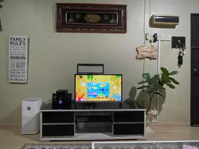 a tv sitting on top of a entertainment center at Myra Homestay Bertam, Penang in Kepala Batas