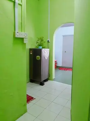 a green room with a refridgerator with a plant on it at Syukur Homestay Ipoh in Ipoh
