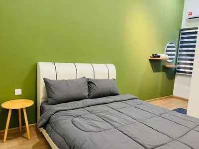 a bedroom with a bed and a green wall at Traveler's Stay @ Ipoh (10Pax) in Ipoh