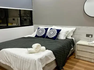 a bedroom with a bed with a towel on it at Traveler's Stay @ Ipoh (10Pax) in Ipoh