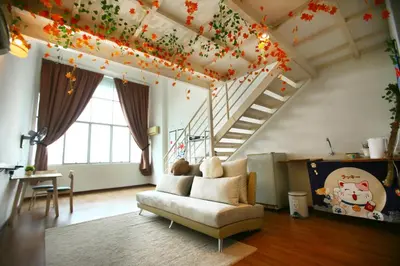 a living room with a couch and a staircase at Private Zen at The CEO Bayan Lepas Penang in Bayan Lepas