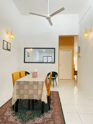 a dining room with a table and yellow chairs at WawAmir Homestay @ Seri Iskandar in Seri Iskandar