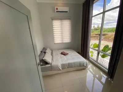 a small bedroom with a bed and a window at Rumah Hana Sekinchan - Mslim0nly in Sekincan