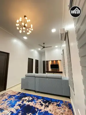 a living room with a blue couch and a fireplace at Rumah Hana Sekinchan - Mslim0nly in Sekincan