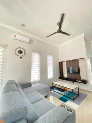 a living room with a couch and a ceiling fan at Rumah Hana Sekinchan - Mslim0nly in Sekincan