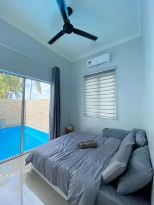a bedroom with a bed and a ceiling fan at Rumah Hana Sekinchan - Mslim0nly in Sekincan