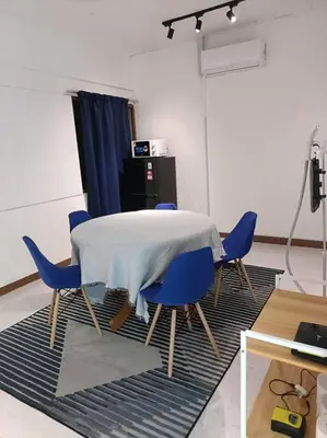 a dining room with a table and blue chairs at 5-Person 1950s Shophouse Vintage Charm Nflix Disney Plus in Taiping