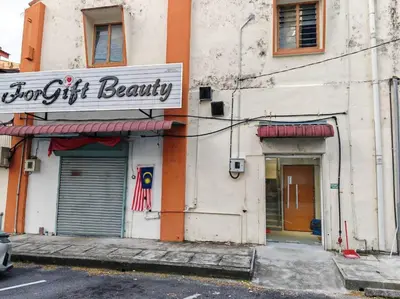 a store with a sign on the side of a building at 5-Person 1950s Shophouse Vintage Charm Nflix Disney Plus in Taiping
