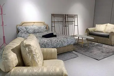 a bedroom with a bed and a couch and a chair at 5-Person 1950s Shophouse Vintage Charm Nflix Disney Plus in Taiping