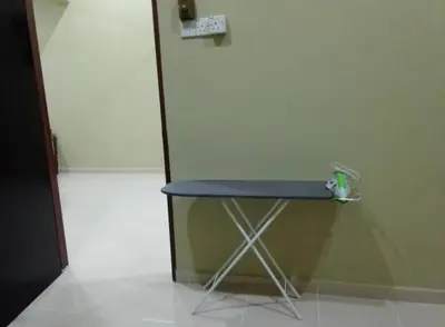 a blue table in a room next to a door at Jentayu homestay in Seri Iskandar