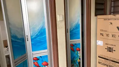 two elevators in a room with a painting of mushrooms at Jentayu homestay in Seri Iskandar