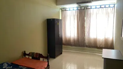 a room with a chair and a door with a window at Jentayu homestay in Seri Iskandar