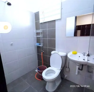 a bathroom with a toilet and a sink at Homestay Nafisah in Tapah Road