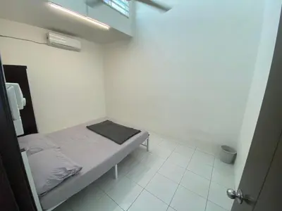 a small white room with a small bed in it at Homestay Nafisah in Tapah Road