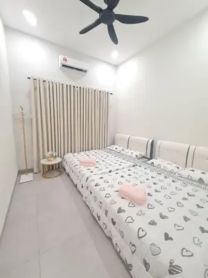 a bedroom with a bed and a ceiling fan at White Sweet Homestay, Kulim Hi-Tech Park Kedah in Kulim