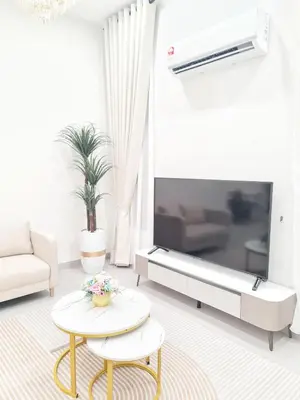 a living room with a large tv and a table at White Sweet Homestay, Kulim Hi-Tech Park Kedah in Kulim